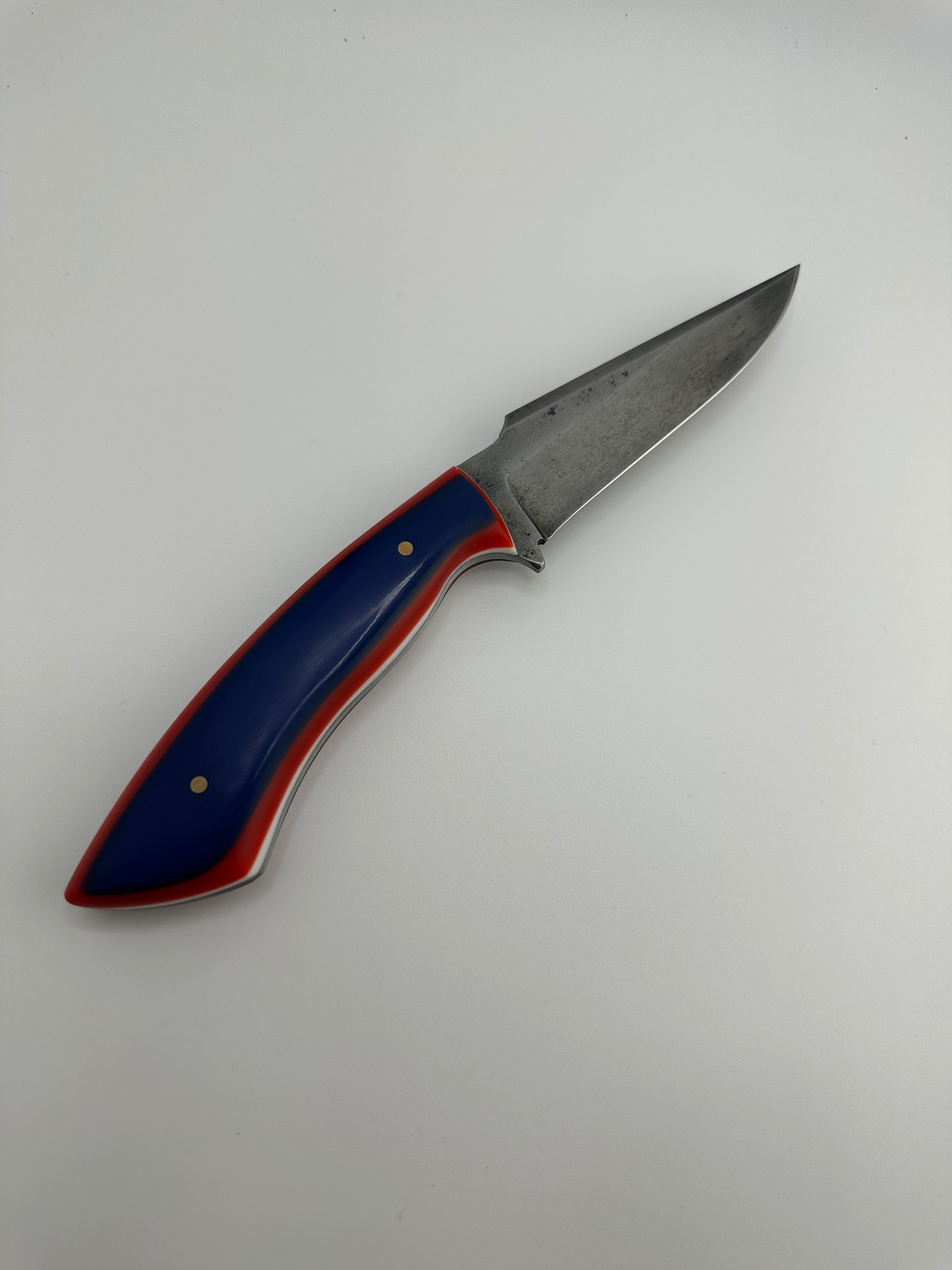 Folding knife with a blue and red handle on a white background