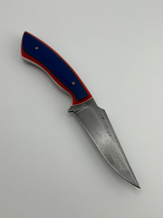 Knife with a blue and red handle on a gray background